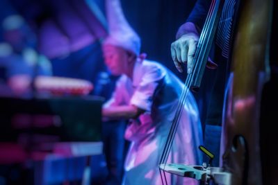 Midsection of musician playing musical equipment