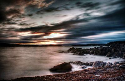 Scenic view of sea against cloudy sky