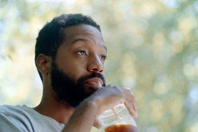 Close-up portrait of man drinking glass