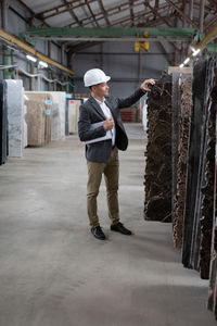 Male worker picking stone in workshop