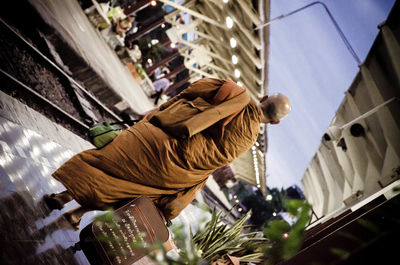 Rear view of monk walking at railroad station