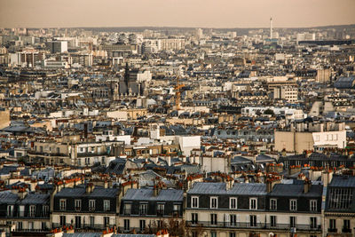 High angle view of houses in town against sky