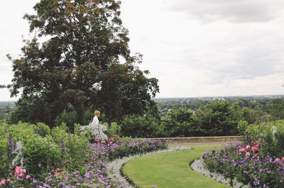 Side view of young woman standing in park