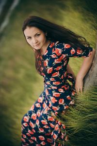 Tilt portrait of woman reclining on field