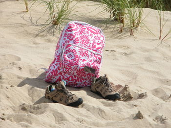 Low section of shoes on sand