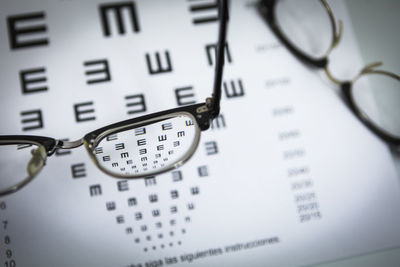 High angle view of eyeglasses on paper