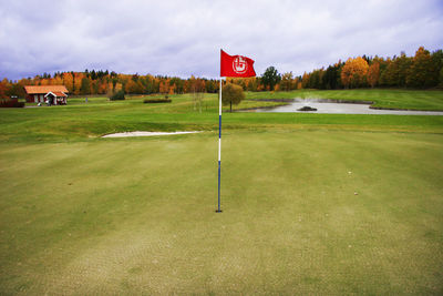 View of golf course on field against sky