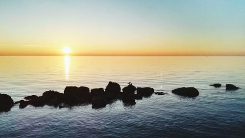 Scenic view of calm sea at sunset