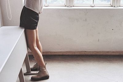 Low section of woman standing on tiled floor