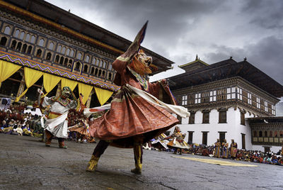 People in traditional clothes dancing during festival