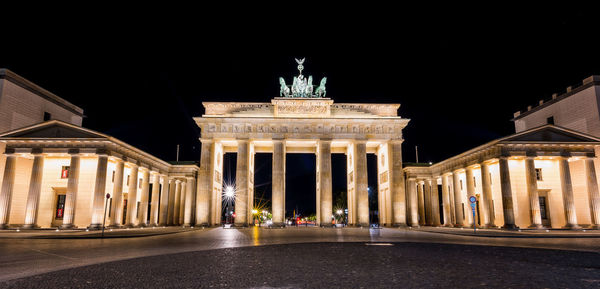 Statue in city at night