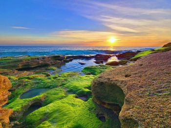 Scenic view of sea against sky during sunrise 