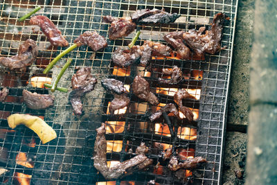 High angle view of meat on barbecue grill