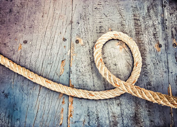 Close-up of rope on wooden floor