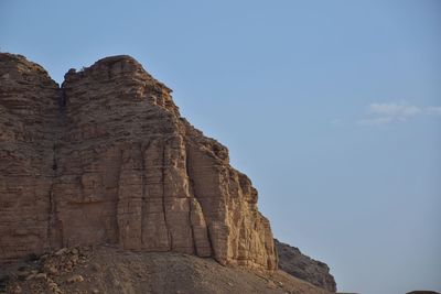 Low angle view of rock formation against sky