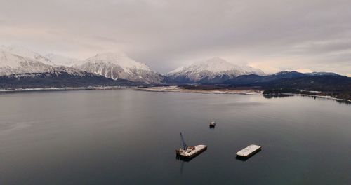 Scenic view of lake and snowcapped mountains against sky