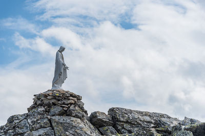 Low angle view of statue against rocks