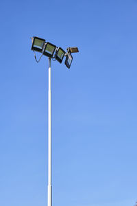 Low angle view of street light against clear blue sky