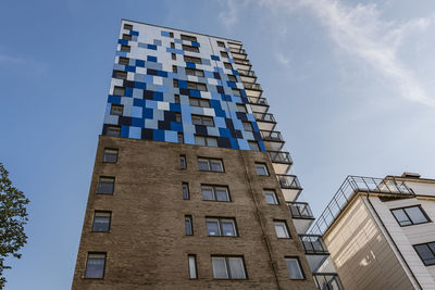 Low angle view of modern building against blue sky