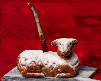 High angle view of ice cream on table against red wall