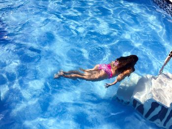 High angle view of woman swimming in pool