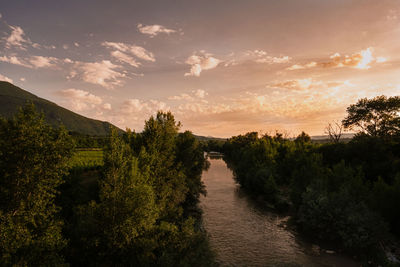 Scenic view of river against sky during sunset