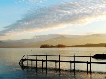 Scenic view of lake against sky during sunset