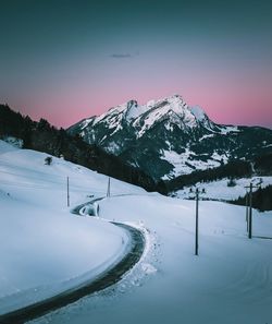 Scenic view of snowcapped mountains against clear sky