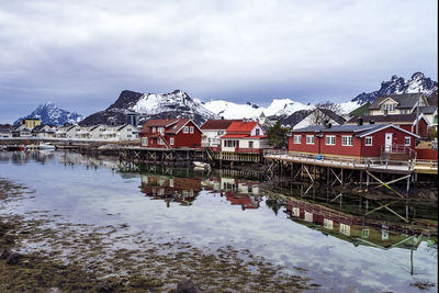 Traditional waterfront buildings reflected on the coast at svolvaer, lofoten islands, norway