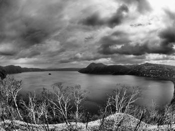 Scenic view of lake and mountains against sky