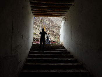 Silhouette people in tunnel