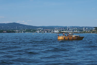 Boat sailing in sea against sky