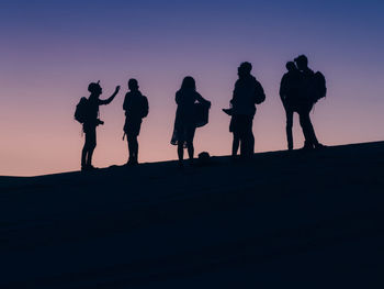 Silhouette people at sunset