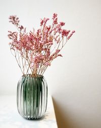 Close-up of pink flower vase on table