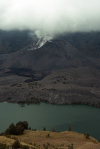 Scenic view of mountains against sky during foggy weather