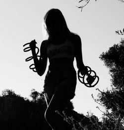 Rear view of woman standing against clear sky