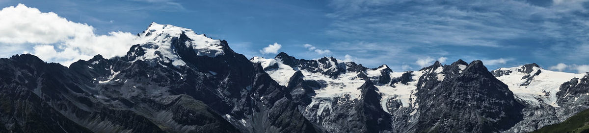 Panoramic view of snowcapped mountains against sky