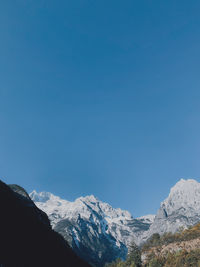 Scenic view of snowcapped mountains against clear blue sky