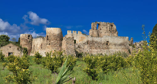 Low angle view of historical building against blue sky