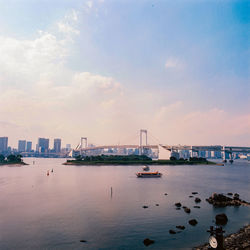 View of suspension bridge over sea against sky