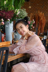 Portrait of a smiling young woman sitting outdoors