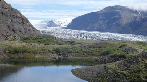 Scenic view of glacier against mountain and sky