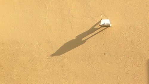 Close-up of light fixture on stucco wall