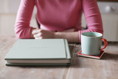 Close-up of woman holding coffee cup