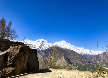 Scenic view of snowcapped mountains against clear blue sky