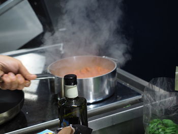 Cropped hand of person preparing food at home