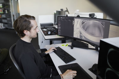 Man at desk using desktop pc