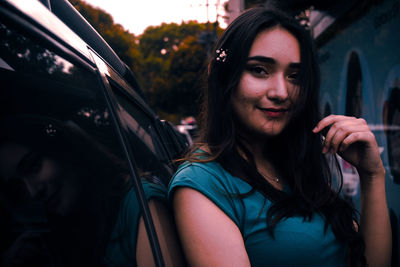 Portrait of smiling young woman in car