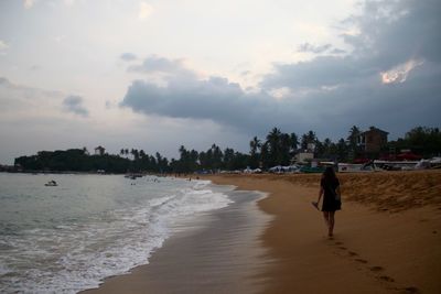 People on beach against sky