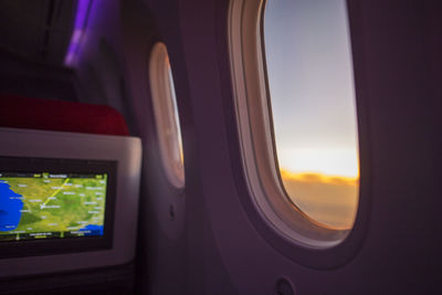 Airplane flying in sky seen through window